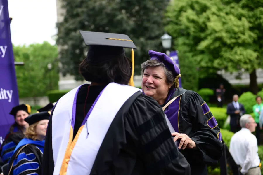 President McGuire conferring a Diploma to a new Trinity graduate