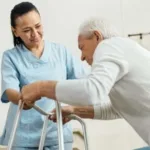 Certified Nursing Assistant helping patient with walker