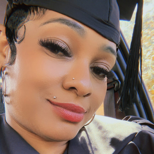Selfie photo of aNieshia McNeal '26 wearing her graduation gown and mortarboard